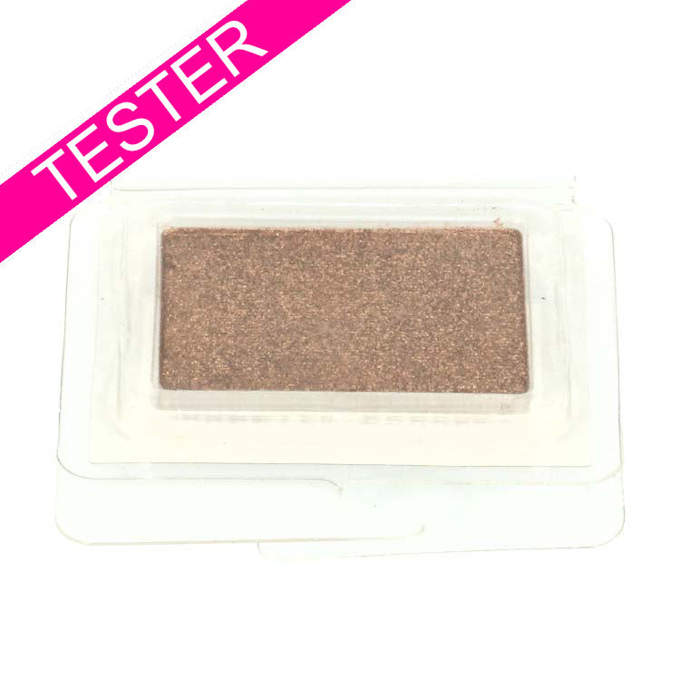 Eyeshadow Monos - Never Learn Tester in een doorzichtige verpakking met een glanzende, bronzen kleur.